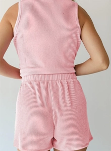 Detail of pink ribbed knit texture on a sleeveless tank top and shorts set for women