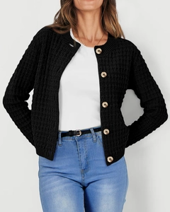 Close-up of black waffle knit cardigan with large wooden buttons and round neckline