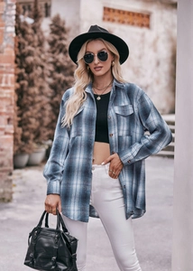 Close-up of blue plaid flannel shirt featuring classic collar and double flap pockets