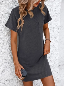 Detailed close-up of dark grey vertical ribbed fabric and chest pocket on a t-shirt dress