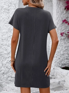 Close-up of dark grey short sleeve dress featuring vertical textured stripes and pockets
