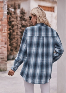 Detailed back view of an oversize blue and white plaid flannel shirt with drop shoulders