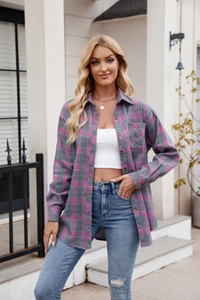Detail of a pink and blue plaid shirt with functional breast pocket and amber buttons