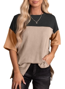 Detail of color-block knit T-shirt featuring ribbed fabric texture and side slit hem