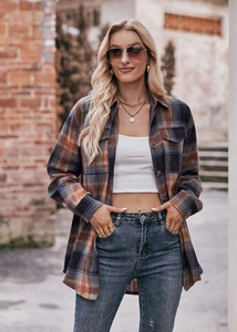 Detail of soft flannel texture on women's oversize plaid shirt with chest pockets