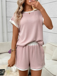 Detail of pink ribbed knit loungewear set with white contrast trim and drawstring waist
