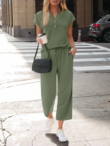 Detail of olive green lounge set showing the V-neck button top and drawstring waistband