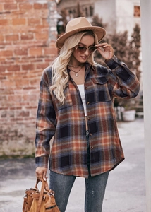 Close-up of vintage oversized plaid flannel shirt with double chest pockets and buttons