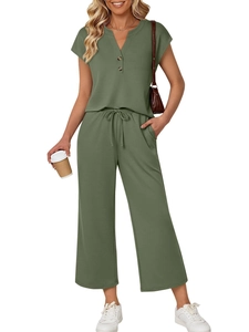 Detail of olive green knitted lounge set showing V-neck henley buttons and drawstring waist
