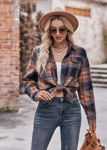 Detailed view of autumn plaid oversized shirt with classic collar and front buttons