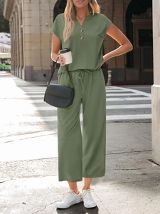Detail of olive green two-piece set with V-neck wooden buttons and drawstring waist