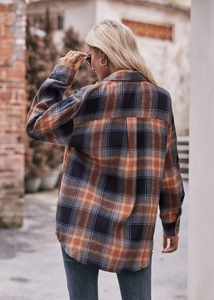 Detailed back view of an oversize plaid shirt with orange and navy blue checkered pattern
