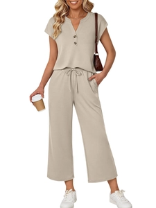 Close-up of beige knit lounge set featuring buttoned V-neck top and drawstring wide-leg pants
