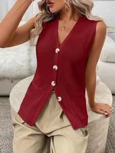 Detail of dark red knit V-neck vest with vertical textures and white buttons
