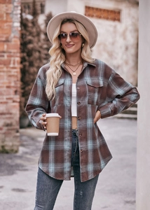 Close-up of brown and blue oversized plaid shacket with dual front flap pockets