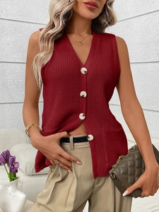 Detail of deep red V-neck knit vest featuring contrast buttons and texture