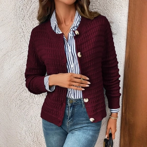 Women's burgundy knit cardigan with waffle texture and gold buttons on a studio model