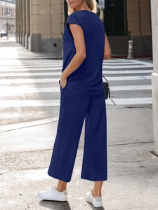 Detail of navy blue two-piece lounge set with short sleeve top and side pocket wide-leg pants