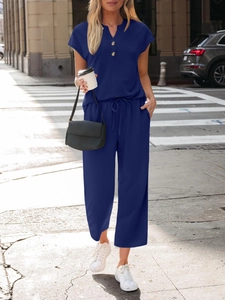Detail of navy blue V-neck short sleeve top and matching drawstring wide leg lounge pants