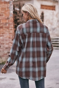 Detail view showing back of oversize brown plaid flannel shirt with relaxed pleated design