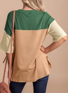 Detail view showing color-block knit texture and drop shoulder design of the loose t-shirt