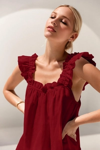 Detailed view of ruffle-trimmed neckline on a burgundy summer tank top and sleepwear set