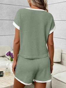 Back view of sage green waffle knit lounge set with white contrast ribbed trim detailing