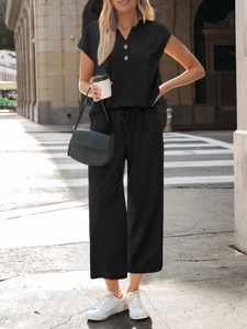 Detail of the V-neck top with wooden buttons and elastic drawstring waist on casual set