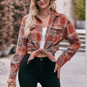 Women's oversize red plaid flannel shirt with front tie detail and long sleeves