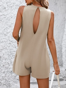 Detail view of the back drop-shaped cutout on this beige sleeveless summer romper