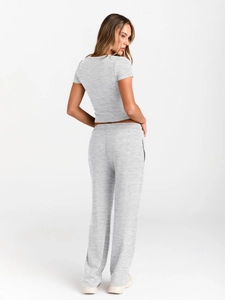 Detail of the back view of a grey marl short sleeve t-shirt and wide-leg trousers set