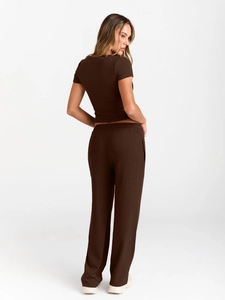 Detail of dark brown short sleeve top and high-waisted wide-leg pants set from a side view