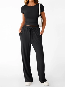Detail of high-waist drawstring wide-leg pants and slim fit t-shirt set in black
