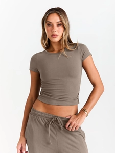 Detail view of the taupe ribbed short-sleeved crop top and matching jogger set texture