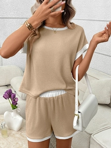 Macro detail of vertical ribbed knit fabric and contrast white piping on loungewear set