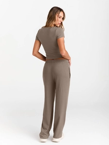Detail showing back view of mocha brown slim short-sleeve top and high-waist wide-leg pants