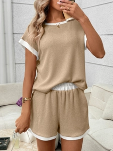 Detail of khaki waffle knit texture and white contrast trim on short sleeve casual set