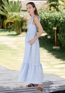 Detail of blue and white plaid maxi dress with shirred bodice and ruffled hemline