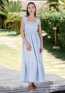 Detailed view of the blue and white gingham dress featuring a smocked bodice and ruffles