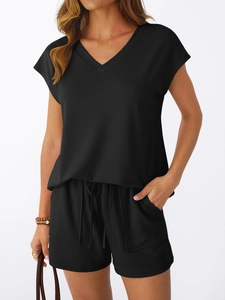 Detail of black V-neck short sleeve top and drawstring shorts with side pockets