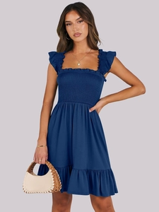 Detail view of navy blue square neck dress with smocked bodice and ruffle hem finish