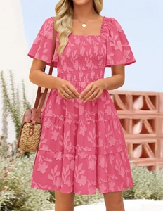 Detail of deep pink square neck floral dress with smocked bodice and tiered ruffle skirt