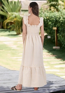 Detail of smocked elastic back and tiered yellow checkered print maxi dress for women