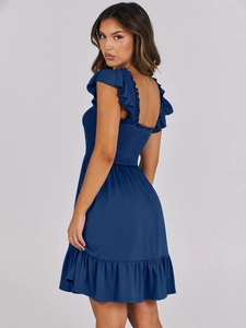 Detail of navy smocked dress featuring ruffled straps and elastic bodice texture