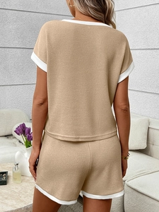 Close-up of waffle knit texture on back of beige and white loungewear set for women