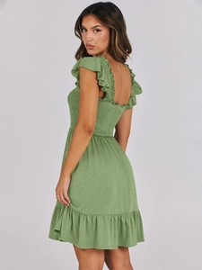 Detailed view of the smocked bodice and ruffled shoulder straps on sage green summer dress