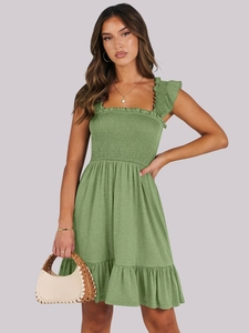 Detail of green smocked dress with ruffled straps and light textured A-line skirt