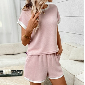 Pink ribbed lounge set with white contrast trim including short sleeve top and shorts