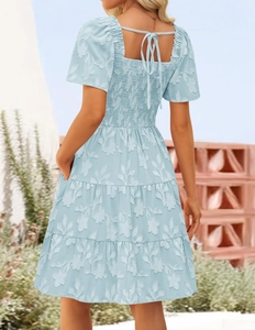 Detail of square neck back tie and tiered floral jacquard skirt on light blue dress