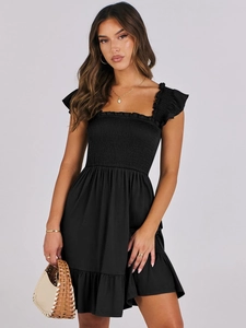 Detail of square neck black dress featuring smocked bodice and ruffled butterfly sleeves